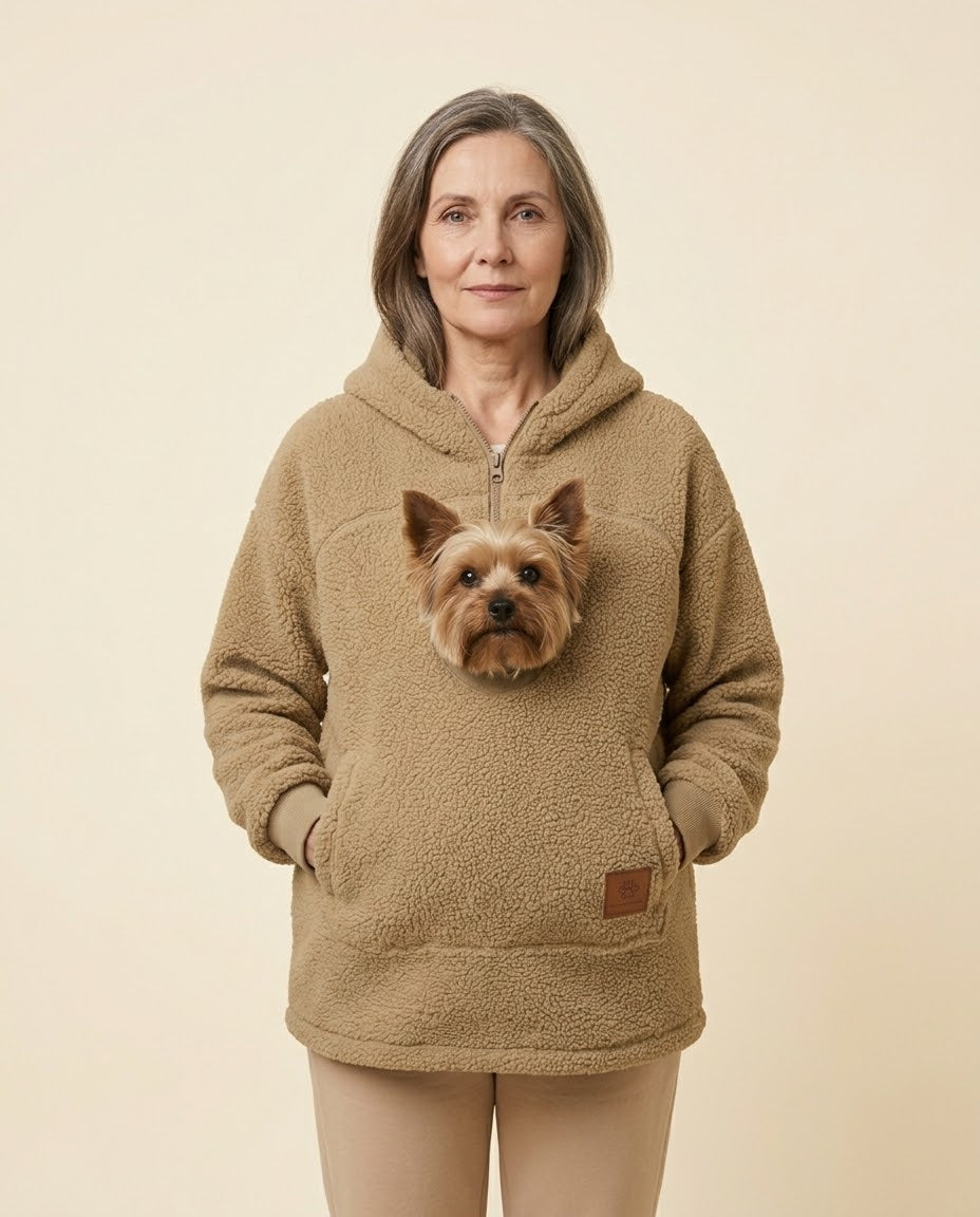 Mujer con la sudadera Dulce de borreguito beige y un yorkshire asomando por el bolsillo delantero, de frente